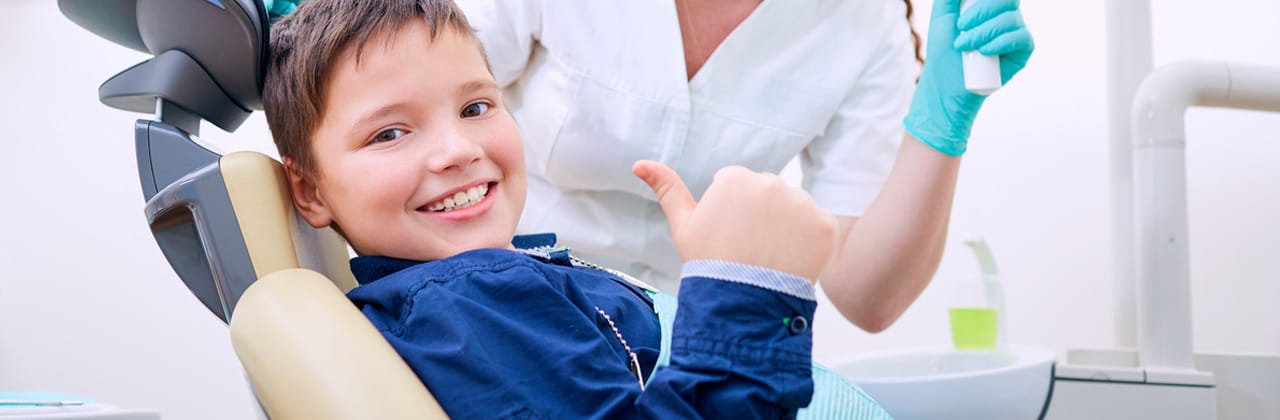 boy sitting on the dentist chair